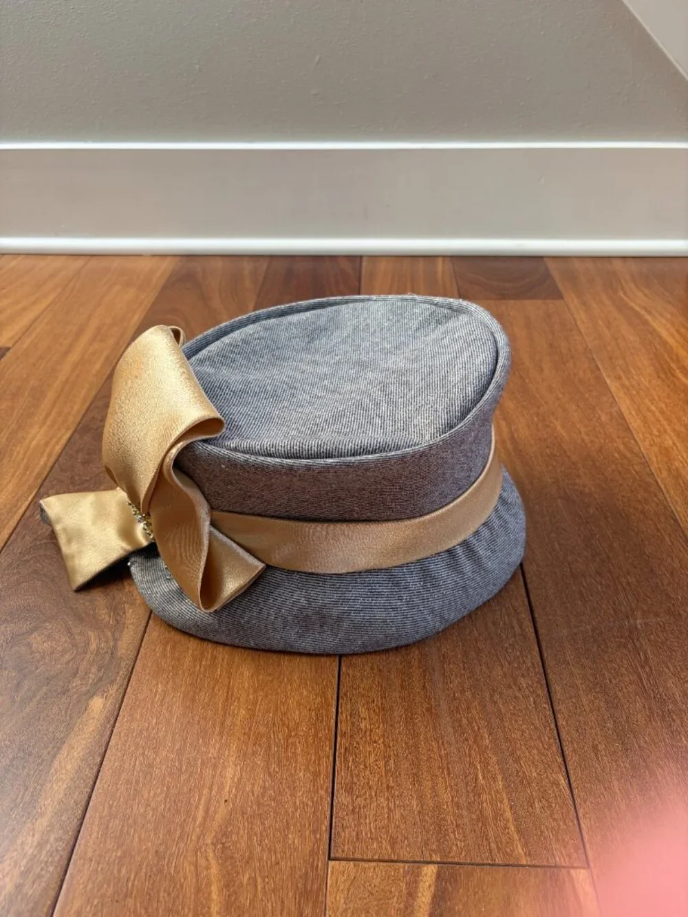 Ms. Divine vintage wool cloche hat with gold flecks while featuring a prominent